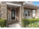 Inviting front entrance with stone columns and a charming welcome sign at 1316 Fountain Hills Ct, Winter Park, FL 32792