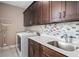 Laundry room with dark cabinets and a utility sink at 1316 Fountain Hills Ct, Winter Park, FL 32792