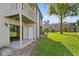 Back exterior view showing patio, lawn, and neighboring building at 134 Springwood Cir # E, Longwood, FL 32750