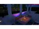 Night view of a rectangular pool with colorful lighting and fire pit at 1429 Chapman Cir, Winter Park, FL 32789