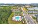 Aerial view of community amenities including a pool, splash pad, soccer pitch, and playground near modern residences at 2736 Bookmark Dr, Kissimmee, FL 34746