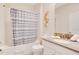 Well-lit bathroom features a shower/tub combo, neutral decor, and a vanity with countertop space at 2736 Bookmark Dr, Kissimmee, FL 34746