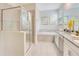 Bathroom with a large mirror, shower, and tub with vanity and countertop space at 2736 Bookmark Dr, Kissimmee, FL 34746