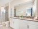Bright bathroom featuring a double vanity, stone countertops, and a glass shower at 2736 Bookmark Dr, Kissimmee, FL 34746