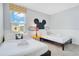 Comfortable bedroom featuring two beds and decor inspired by Mickey Mouse at 2736 Bookmark Dr, Kissimmee, FL 34746