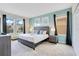 Comfortable bedroom with a king bed, light blue accent wall, and plenty of natural light at 2736 Bookmark Dr, Kissimmee, FL 34746