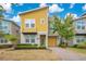 Modern two-story home featuring a bright yellow facade, attached garage, and meticulously manicured landscaping at 2736 Bookmark Dr, Kissimmee, FL 34746