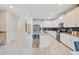 Modern kitchen with white cabinets, stainless steel appliances, and a spacious center island with seating at 2736 Bookmark Dr, Kissimmee, FL 34746