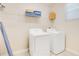 Functional laundry room with a washer, dryer, shelving, and storage space at 2736 Bookmark Dr, Kissimmee, FL 34746
