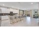 Bright, open concept living room with dining area that extends to the outdoor patio and overlooks the kitchen at 2736 Bookmark Dr, Kissimmee, FL 34746