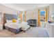 Cozy main bedroom with a plush bed, a crib, lots of natural light, and stylish decor at 2736 Bookmark Dr, Kissimmee, FL 34746