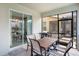 Covered patio with an outdoor dining table, chairs, and a built-in grill at 2736 Bookmark Dr, Kissimmee, FL 34746