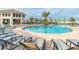 Stunning community pool with ample lounge chairs, palm trees and an outdoor bar, perfect for relaxation and social gatherings at 2736 Bookmark Dr, Kissimmee, FL 34746