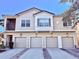 A street view of a two-story townhome featuring individual garages and a private balcony at 2856 Oakwater Dr # 2856, Kissimmee, FL 34747