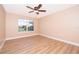 Bright bedroom with wood-look floors and ceiling fan at 51 Andora Ct, Kissimmee, FL 34758