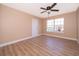 Spacious bedroom featuring wood-look floors and a large window at 51 Andora Ct, Kissimmee, FL 34758