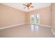 Spacious bedroom with tile floors and access to the backyard at 51 Andora Ct, Kissimmee, FL 34758