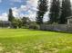 Large backyard with expansive grassy lawn and water feature at 519 Lakescape Ct, Orlando, FL 32828