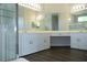 Modern bathroom featuring a double vanity with sleek white cabinets and a separate glass-enclosed shower at 519 Lakescape Ct, Orlando, FL 32828
