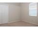 Cozy bedroom with neutral carpet, window, and built in closet at 519 Lakescape Ct, Orlando, FL 32828