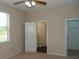 Bright bedroom with a ceiling fan, neutral carpet, and an ensuite bathroom at 519 Lakescape Ct, Orlando, FL 32828