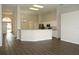 Open-concept living area with hardwood flooring and a breakfast bar connecting to the adjacent kitchen at 519 Lakescape Ct, Orlando, FL 32828