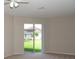 Light-filled living room with a sliding glass door leading to the backyard and a view of the landscaped yard at 519 Lakescape Ct, Orlando, FL 32828