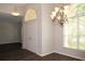 Elegant living room with hardwood floors, chandelier, large window and view to the front yard at 519 Lakescape Ct, Orlando, FL 32828