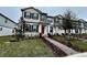 Modern two-story townhouses with red doors and neatly landscaped yards at 783 Pilea St, Apopka, FL 32703