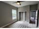 Cozy bedroom with a ceiling fan, closet, and large window overlooking the front yard at 0 Sabal St, Orlando, FL 32833