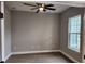 Bedroom with neutral walls, ceiling fan, wood look floors, and natural light from a single window at 0 Sabal St, Orlando, FL 32833