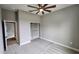 Neutral bedroom featuring a ceiling fan, patterned carpet, and built-in closet space at 0 Sabal St, Orlando, FL 32833