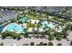 Stunning aerial shot of community pool with palm trees, lounge chairs, and recreational green spaces at 10133 Peebles St, Orlando, FL 32827