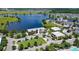 Attractive aerial view of the community clubhouse, commercial areas, and lake amenities at 10133 Peebles St, Orlando, FL 32827