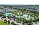 Beautiful aerial view of the community pool area, lined with lush landscaping and ample parking at 10133 Peebles St, Orlando, FL 32827