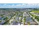 Large aerial view showcasing the community neighborhood with green space and a lake in the background at 10133 Peebles St, Orlando, FL 32827