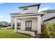 Exterior view of the house with a covered patio and manicured lawn at 10133 Peebles St, Orlando, FL 32827