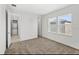 Bright bedroom with neutral carpet, white walls, and two windows letting in natural light at 10133 Peebles St, Orlando, FL 32827