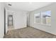 Bright bedroom with neutral carpet, white walls, and two windows letting in natural light at 10133 Peebles St, Orlando, FL 32827