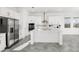 Modern kitchen with stainless steel appliances, white cabinetry, large center island, and bright natural light at 10133 Peebles St, Orlando, FL 32827