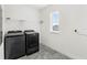 Functional laundry room featuring modern washer and dryer units, with ample space and natural light at 10133 Peebles St, Orlando, FL 32827