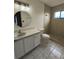 Clean bathroom with a tiled walk-in shower, vanity with storage, toilet, and neutral colors at 2168 Meadow Ct, Apopka, FL 32703