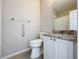 Cozy bathroom features granite counters, grab bars and a pristine toilet at 349 Alcove Dr, Groveland, FL 34736