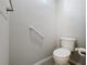 Cozy bathroom features grab bars and a pristine toilet at 349 Alcove Dr, Groveland, FL 34736