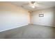 Neutral bedroom with carpet, ceiling fan, and minimal furnishings, offering a blank canvas at 349 Alcove Dr, Groveland, FL 34736