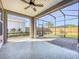 Spacious screened-in lanai with a ceiling fan overlooking the backyard, ideal for outdoor living at 349 Alcove Dr, Groveland, FL 34736