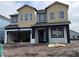 Two-story home with neutral siding, dark trim, and a two-car garage at 5069 Rain Shadow Dr, Saint Cloud, FL 34772