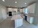 Bright kitchen with white cabinets, modern appliances, and large island, perfect for entertaining at 5069 Rain Shadow Dr, Saint Cloud, FL 34772