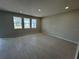 Spacious living room featuring wood-look flooring, recessed lighting, and natural light from large windows at 5069 Rain Shadow Dr, Saint Cloud, FL 34772