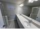 Bathroom with double sinks, granite countertops, and glass enclosed shower at 5084 Rain Shadow Dr, Saint Cloud, FL 34772